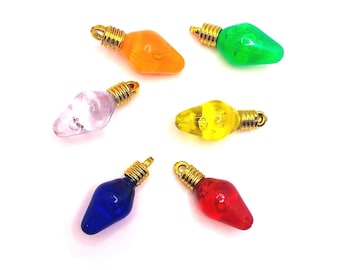 May include: Six colorful plastic Christmas light bulb charms with gold wire loops. The bulbs are red, orange, yellow, green, blue, and purple.