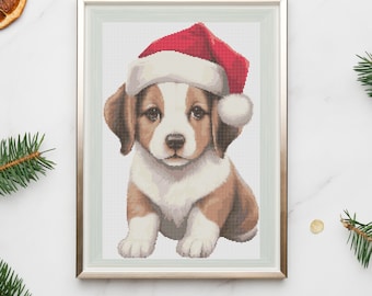May include: A framed cross-stitch image of a brown and white puppy wearing a red Santa hat. The puppy is sitting and looking at the viewer.