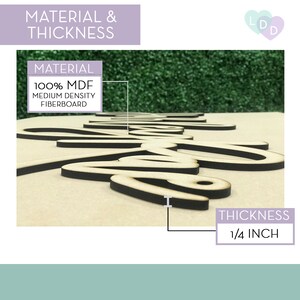 May include: A close-up of a wooden sign with the word "Love" written in cursive. The sign is made of 1/4 inch thick MDF, which is a medium density fibreboard. The sign is painted black and has a natural wood finish.