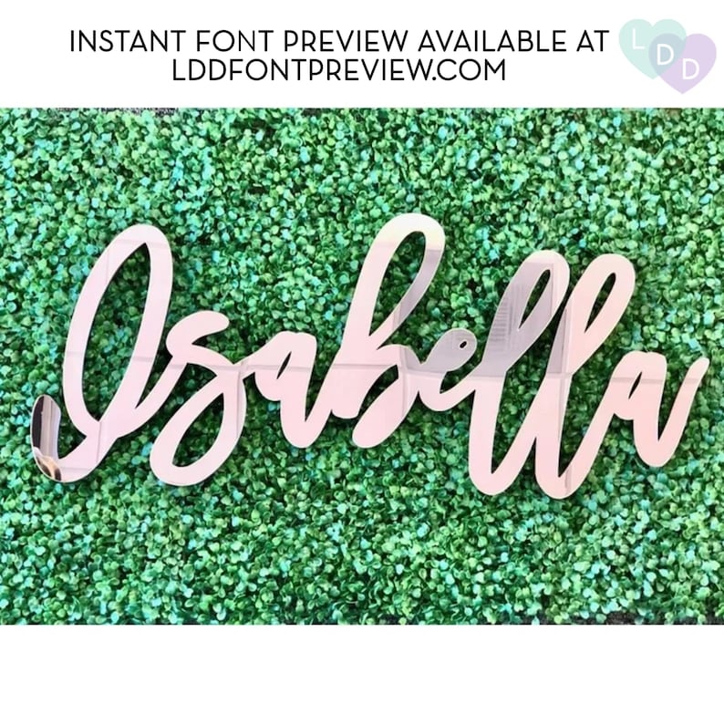 May include: A cursive, mirrored-finish sign spelling "Isabella" in a decorative font. The sign is mounted on a green textured background. The text "INSTANT FONT PREVIEW AVAILABLE AT LDDFONTPREVIEW.COM" is at the top.