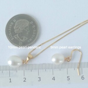 May include: A set of pearl jewelry featuring a 10mm pearl pendant on a gold chain and 9mm pearl earrings. The pearls are white and the jewelry is measured against a ruler.