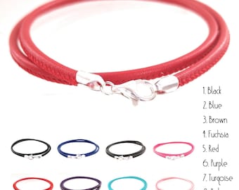 May include: A red leather wrap bracelet with a silver-colored clasp. The image also shows examples of the bracelet in black, blue, brown, fuchsia, purple, turquoise, and pink.