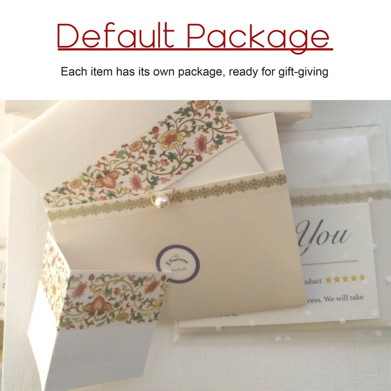 May include: A white gift box with a floral design and a pearl accent. The box is open and the inside is lined with white paper. The box is labeled "El Sastre" and has the text "You" on the side. The text "oduct" and five stars are also visible.