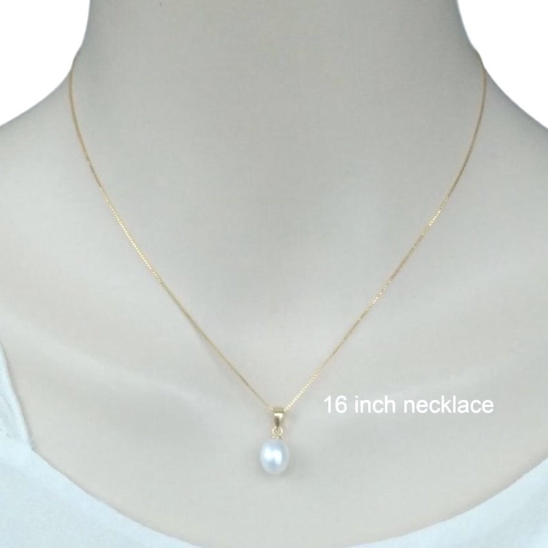 May include: A simple gold chain necklace with a single white pearl pendant. The necklace is 16 inches long.