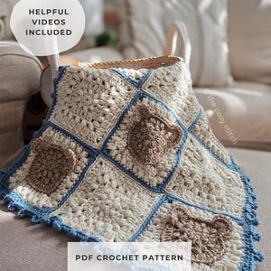 May include: A cream crochet blanket with blue edging and brown bear appliqués. The blanket has a square pattern with a blue border and bear designs. Text on the image reads "Helpful Videos Included" and "PDF Crochet Pattern".