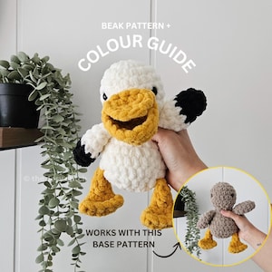 May include: A handmade crochet duck toy with a white body, yellow beak and feet, and black accents on the wings. The image includes text that reads "BEAK PATTERN + COLOUR GUIDE" and "WORKS WITH THIS BASE PATTERN".