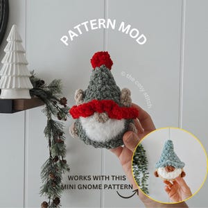May include: A handmade crochet gnome with a gray hat, red scarf, and white beard. The gnome has a red pom-pom on top of its hat. The text "PATTERN MOD" and "WORKS WITH THIS MINI GNOME PATTERN" are visible.