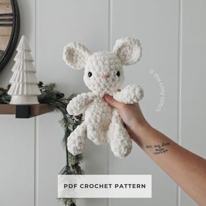 May include: A white ceramic mug with a black handle and the text "But First, Coffee" in a black, bold font. The mug is on a white surface. The mug is approximately 4 inches tall.