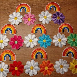 May include: A white ceramic mug with a black handle and the text "But First, Coffee" in a bold, black font. The mug is set against a blurred background, suggesting a cozy setting.