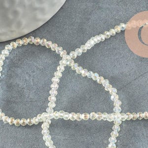 Cuentas de cristal facetadas iridiscentes color beige con forma de ábaco, 2x2,5 mm, 1 tira de 42 cm (G4705)