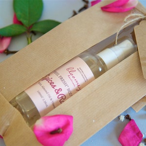 Spices & Roses Moisturizing Body Oil beautifully packaged in a kraft paper bag with a "Made with love" stamped Kraft Tag on it