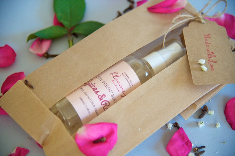 Spices & Roses Moisturizing Body Oil beautifully packaged in a kraft paper bag with a "Made with love" stamped Kraft Tag on it