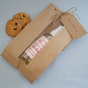 Cookies Moisturizing Body Oil beautifully packaged in a kraft paper bag with a "Made with Love" Kraft Tag on it