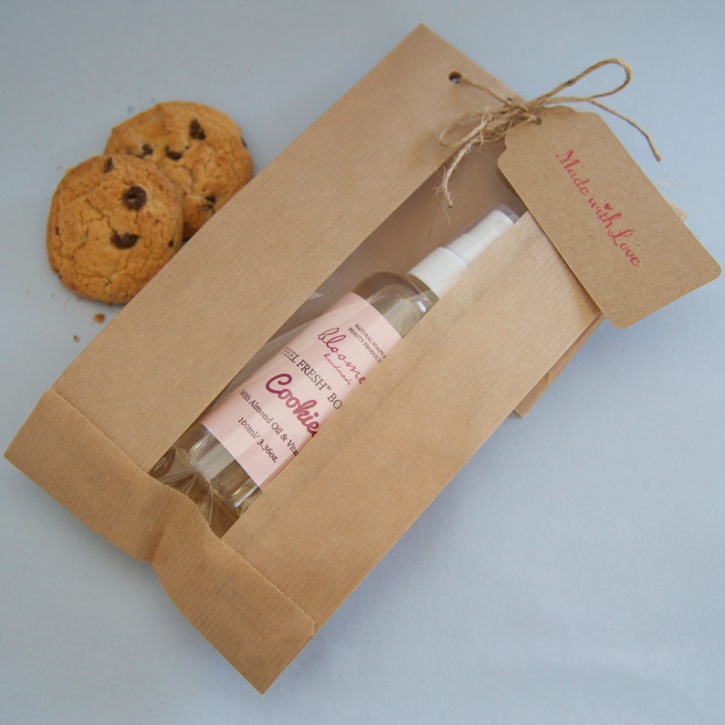 Cookies Moisturizing Body Oil beautifully packaged in a kraft paper bag with a "Made with Love" Kraft Tag on it