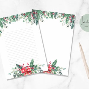 May include: Two printable sheets of lined paper with a watercolor border of green leaves, red berries, and a red and white plaid bow at the bottom. The top of the paper has a border of the same watercolor design.