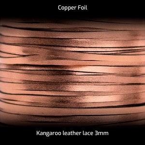 May include: Close-up of a spool of copper foil kangaroo leather lace, 3mm wide. The leather is a warm, reddish-brown color.