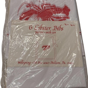 May include: A package of six lobster bibs, made of plastic with ties. The bibs are white with a red lobster graphic. The packaging includes the text "6 Lobster Bibs plastic-with ties".