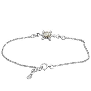 May include: A silver anklet with a turtle charm, featuring a white and tan shell. The anklet has a delicate chain and an adjustable clasp. The turtle charm is the focal point of the anklet.