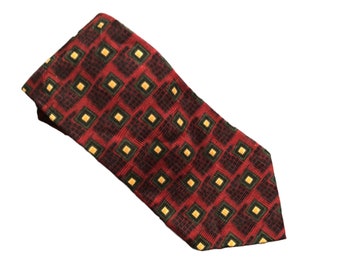 May include: A red tie with a geometric pattern of black, green, and yellow squares.