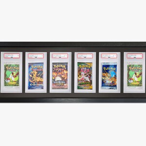 May include: A black frame with six openings displays six Pokemon cards. The cards are all different and feature various Pokemon characters. The cards are all in protective plastic sleeves.
