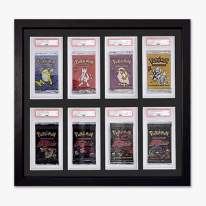 May include: Framed display of eight Pokémon trading card packs. The packs feature various designs and colors, including blue, red, purple, and gold. The frame is black, and each pack is encased in a protective holder with a white border.