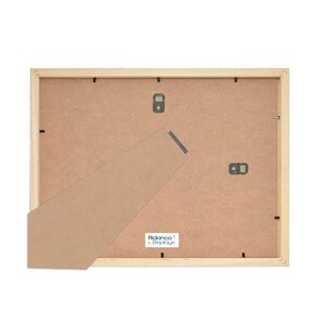 May include: The back of a light wood picture frame with a brown cardboard backing. The frame has a built-in easel stand and a label that reads "Ribbaco&reg; Displays".