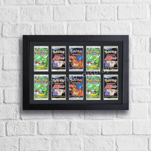 May include: A black frame with nine Pokemon trading cards inside. The cards feature a green and red background with a Pokemon character on each card. The text on the cards reads "Pokemon" and "R/R".
