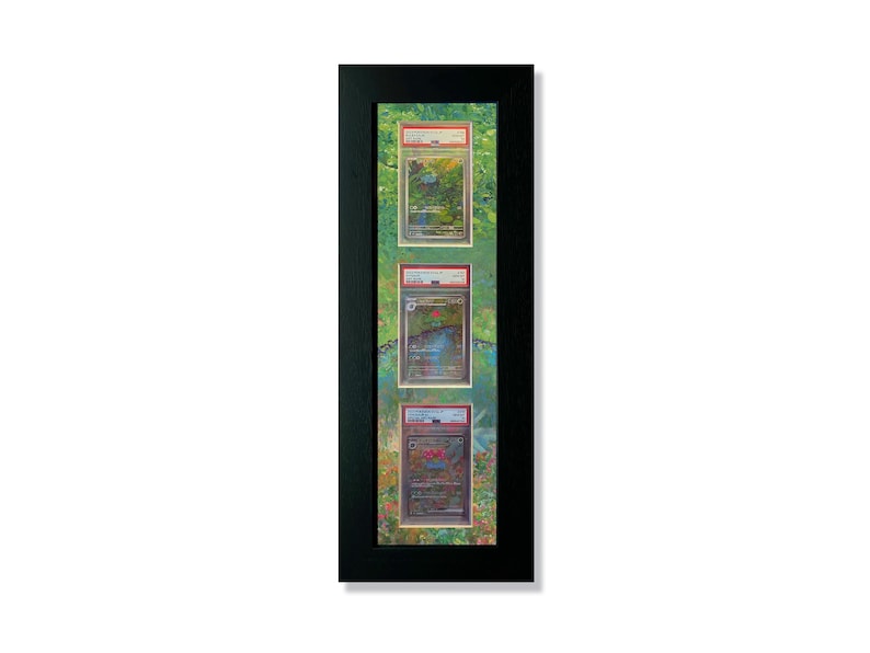 May include: A black frame with a green mount and three cards inside. The cards are all different and feature a variety of colours and designs.