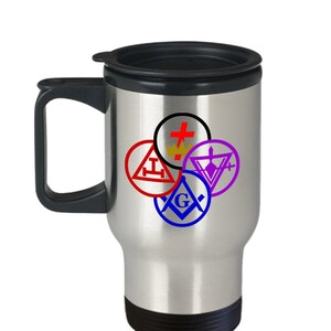 May include: A stainless steel travel mug with a black handle, lid, and base. The mug features colorful Masonic symbols in red, blue, purple, and black. The symbols are arranged in a circular pattern on the front of the mug.
