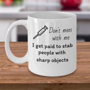 Registered Nurse doctor coffee mug - Don't mess with me I get paid to stab people with sharp objects - Funny hospital staff gifts