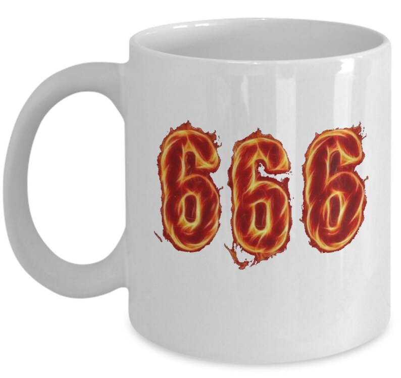 May include: White ceramic coffee mug with the number 666 in fiery orange and red flames.