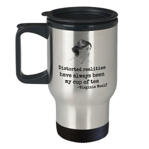 May include: Stainless steel travel mug with a black lid and handle. The mug features a black and white illustration of Virginia Woolf and a quote: "Distorted realities have always been my cup of tea - Virginia Woolf"