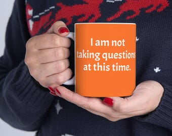 ROROTOKO I am not taking questions at this time Mug. Orange text ceramic coffee cup