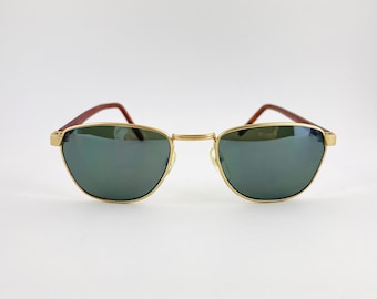 May include: Gold-tone metal sunglasses with dark green lenses and brown plastic arms.