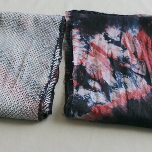 May include: Two fabric swatches, one with a white and gray geometric pattern and the other with a tie-dye pattern in shades of red, blue, and white.