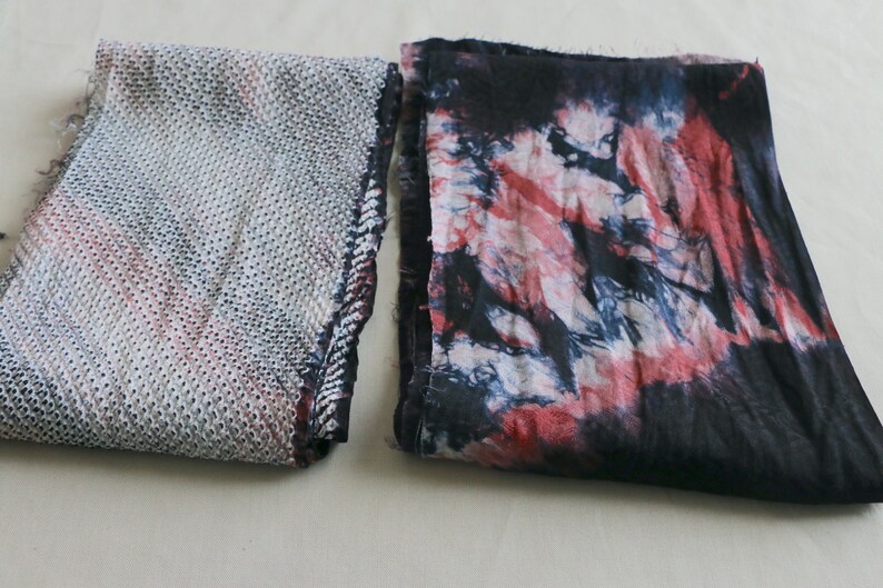 May include: Two fabric swatches, one with a white and gray geometric pattern and the other with a tie-dye pattern in shades of red, blue, and white.