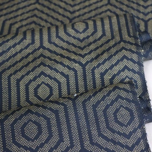 May include: Black fabric with a gold geometric pattern of hexagons.