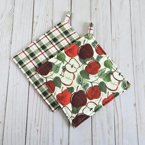 May include: A white ceramic mug with a black handle and the text "But First, Coffee" in a black, handwritten-style font. The mug is on a white surface.