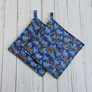 May include: A set of three ceramic mugs with a speckled, matte finish. The mugs are in shades of cream, light brown, and dark brown. Each mug has a simple, minimalist design, perfect for coffee or tea.