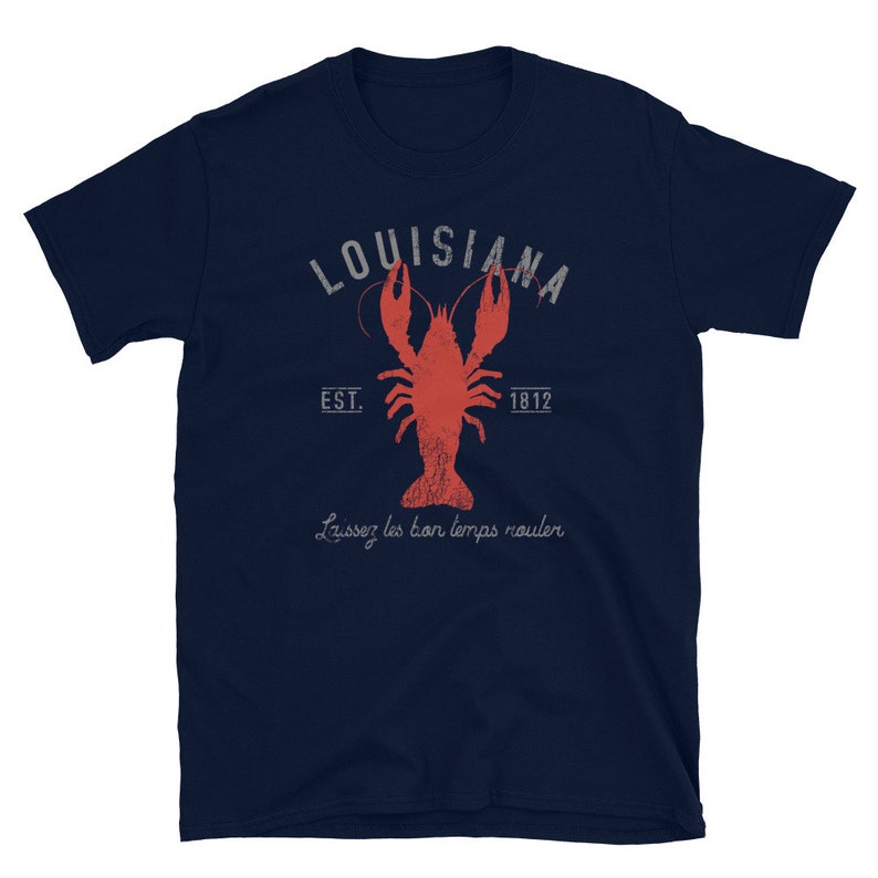 May include: A navy blue t-shirt with a distressed white graphic of a crawfish and the text "Louisiana Est. 1812" and the phrase "Laissez les bon temps rouler".
