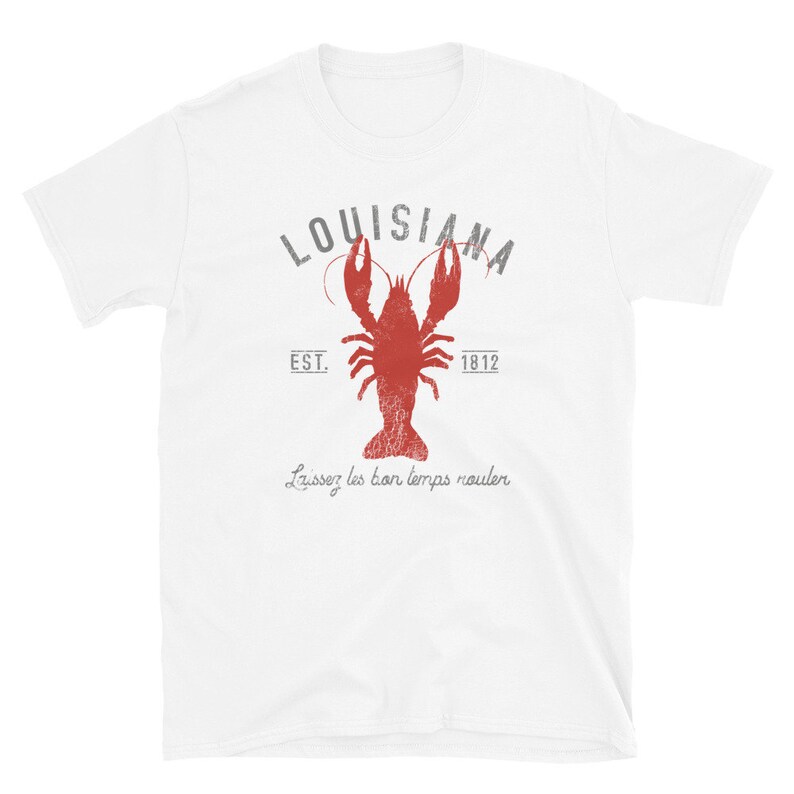 May include: White t-shirt with a red crawfish and the text "LOUISIANA EST. 1812 Laissez les bon temps rouler" printed on the front.