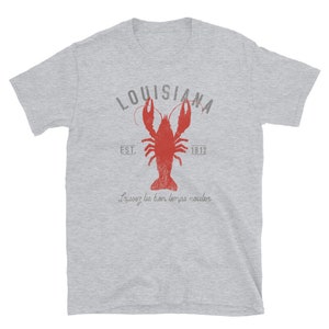 May include: A gray t-shirt with a vintage-style graphic of a red crawfish, the words "Louisiana" and "Est. 1812", and the phrase "Laissez les bon temps rouler".