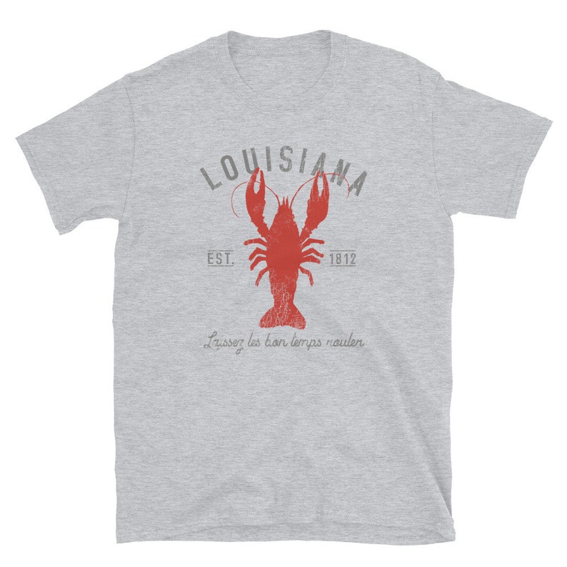 May include: A gray t-shirt with a vintage-style graphic of a red crawfish, the words "Louisiana" and "Est. 1812", and the phrase "Laissez les bon temps rouler".