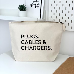 May include: A white canvas zippered pouch with black text that reads "PLUGS, CABLES & CHARGERS."