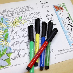 May include: A coloring page with a quote about the Bible, a flower illustration, and the words "The Book of Psalms".  There are six colorful markers on top of the page.