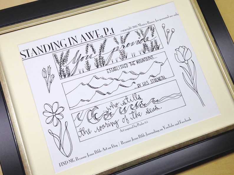May include: Framed black and white art print with the text "STANDING IN AWE, P.1". The artwork features floral and mountain illustrations with script lettering. The print is framed in a black and gold frame.