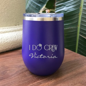 May include: Purple stainless steel tumbler with a white inscription that reads "I Do Crew Victoria" with a diamond symbol.