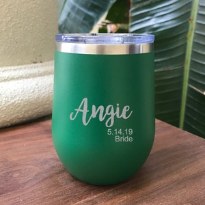 May include: Green stainless steel tumbler with the name Angie, the date 5.14.19, and the word Bride engraved on it.