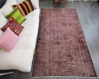 Maroon Vintage Turkish kilim rug with faded pink and a worn patina