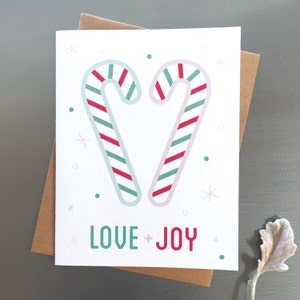 Love + Joy – Corazón de bastón de caramelo, linda, dulce y extravagante tarjeta navideña